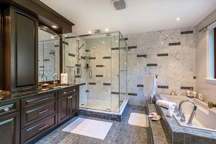 Elegant bathroom with Tub and plexiglass shower.