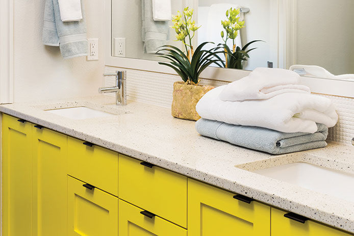 Sink in Master Bathroom in Luxury Home detail closeup of sink, faucet, countertop,yellow cabinets, and mirror