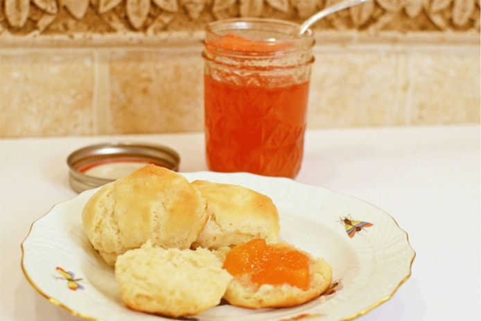 Jar of peach jam and biscuits