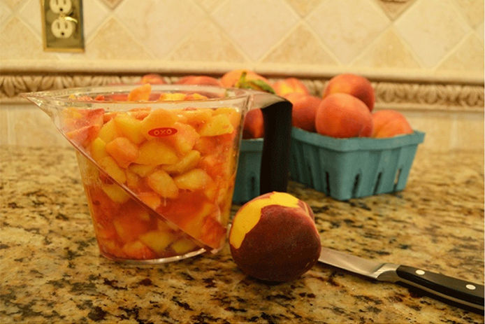 Peaches cut up and put in a measuring cup