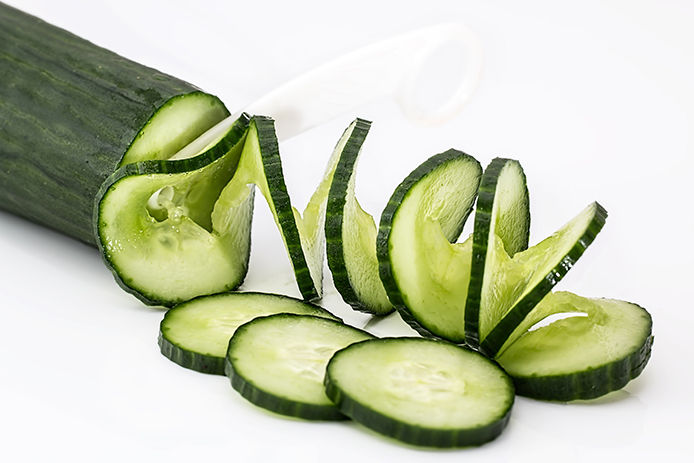 Sliced up cucumber on white background