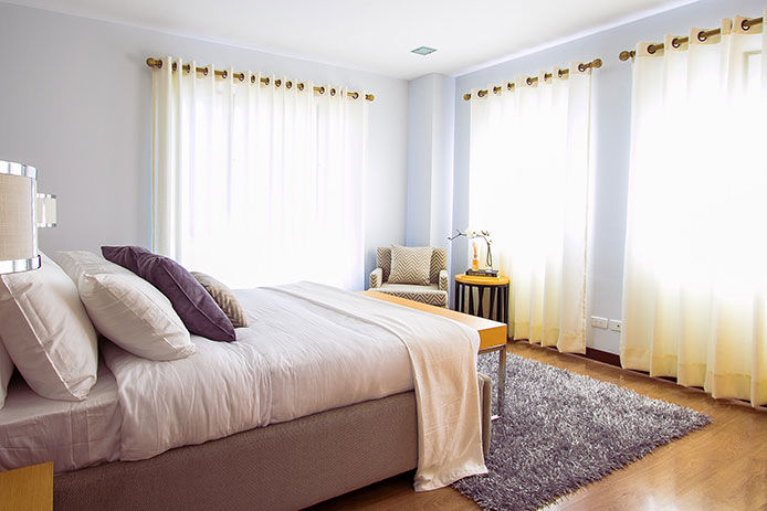 A bedroom with curtains covering the windows