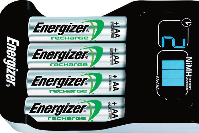 A black Energizer brand battery charging unit for rechargeable AA and AAA batteries is shown holding four silver AA Energizer Recharge Batteries. 