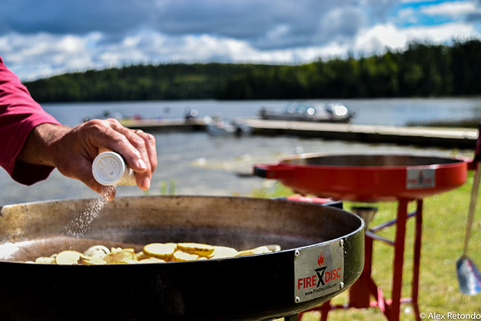 Person seasoning food on the FireDisc