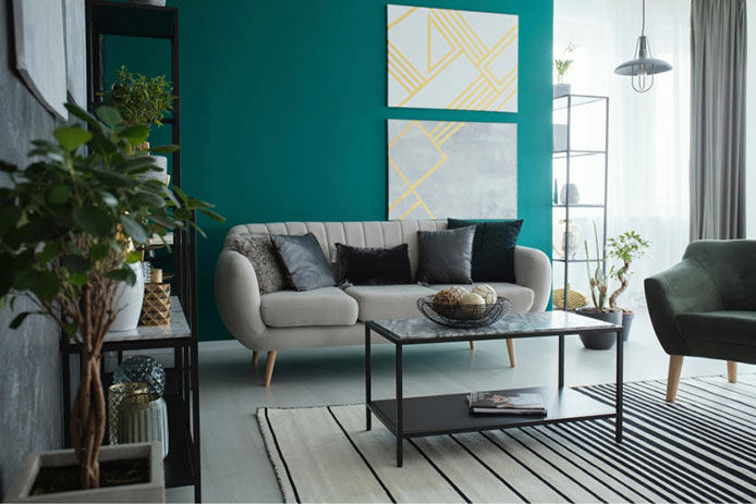 Green accent wall behind living room sofa