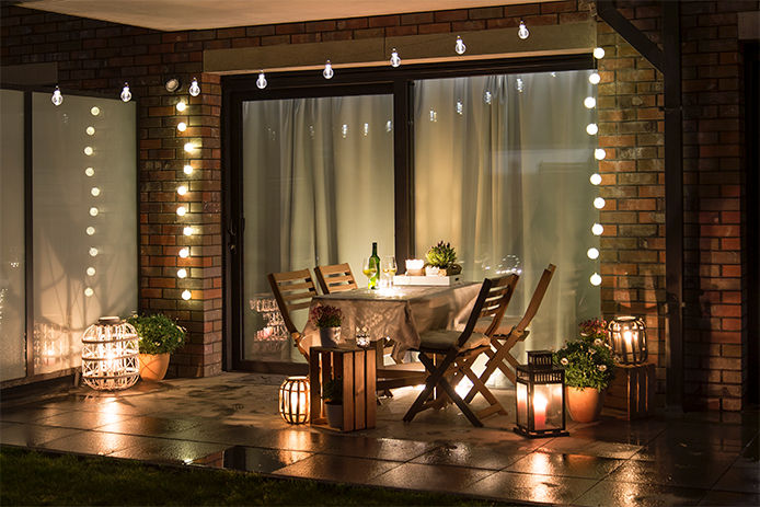 An outdoor patio with decortive string lights