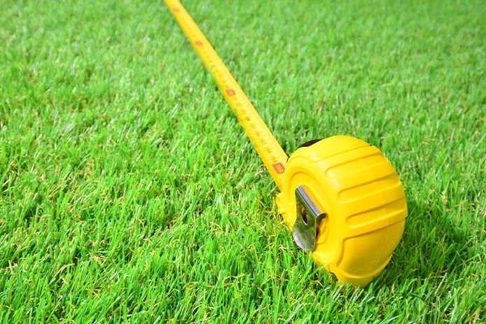 A tape measure laying in the grass