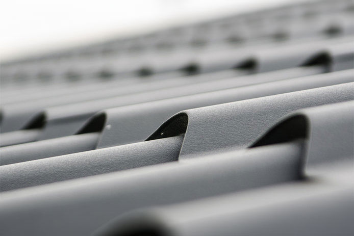 a close up of a gray slated metal roof