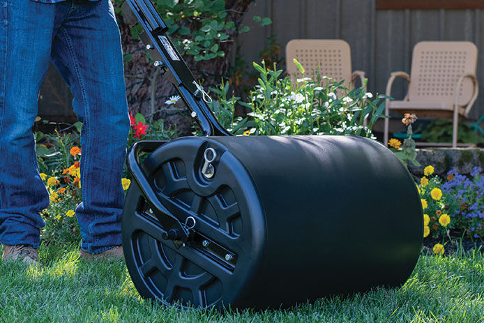 Person using a roller on grass