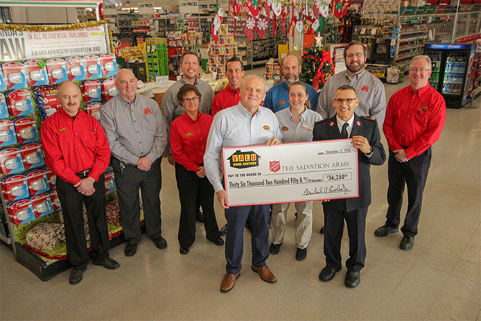 Store employees presenting Salvation Army with check