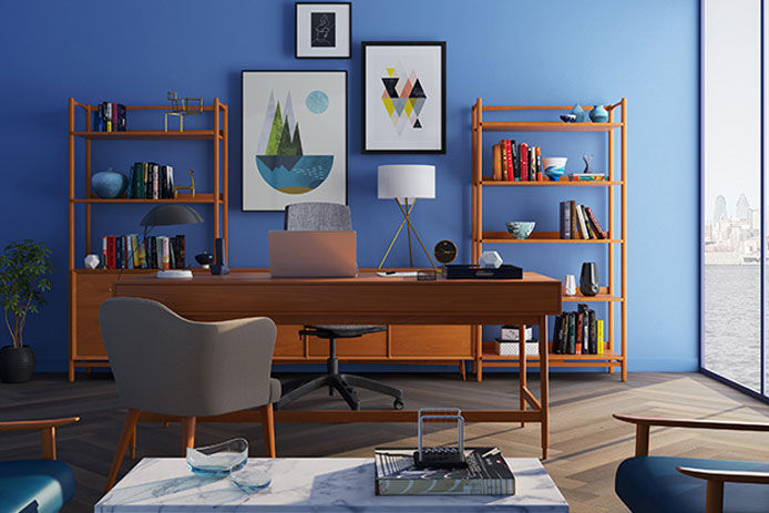 an at home office with a blue accent wall and wooden desk and shelves 