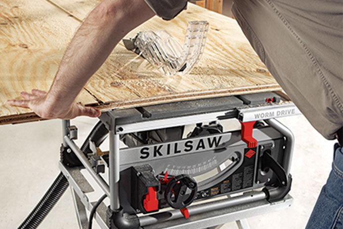 A SKILSAW tabletop bench saw being used to cut through plywood