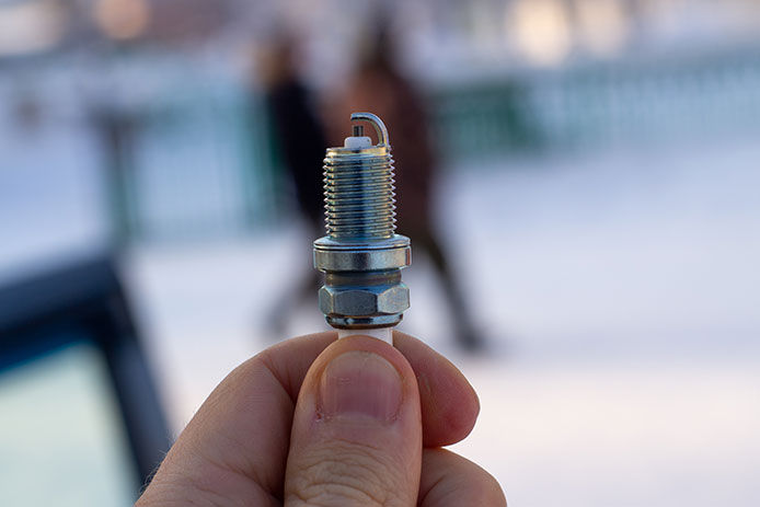 Hand holding a spark plug