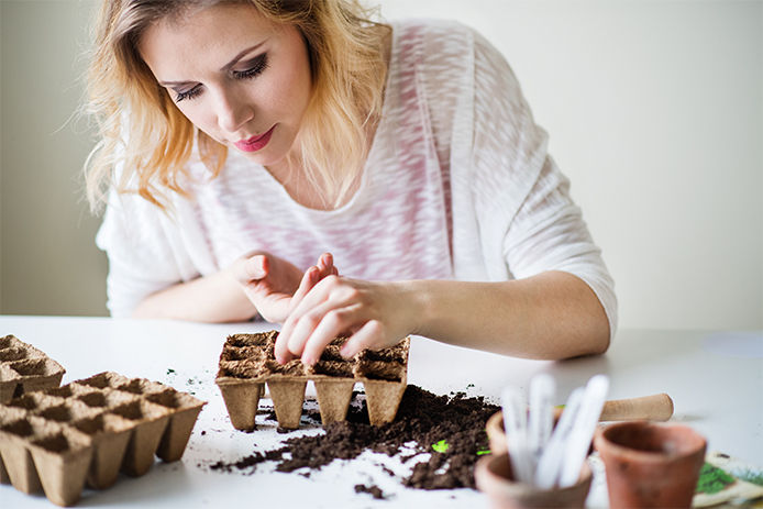A woman planting seeds