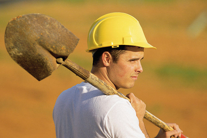 A construction man holding a shovel