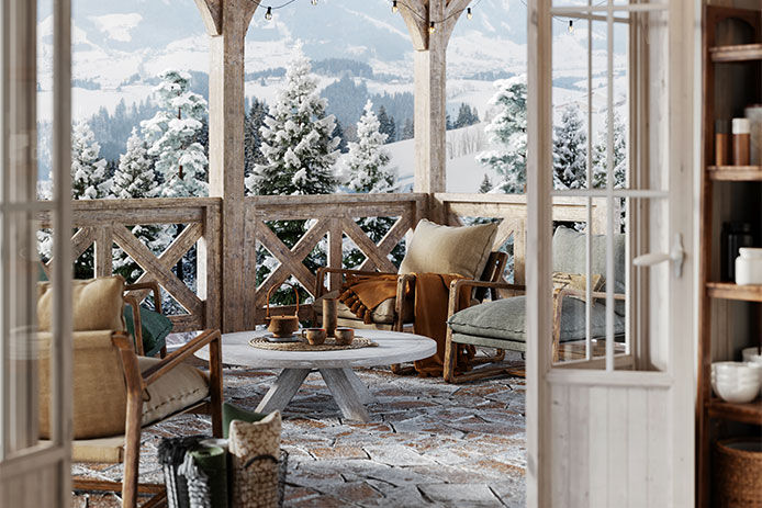 Patio terrace with stunning views of snow-covered mountains in the background, featuring a cozy seating area with cushions and blankets for relaxation.
