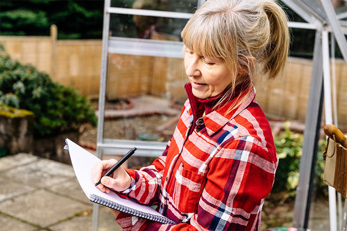 A woman planning out her yardwork