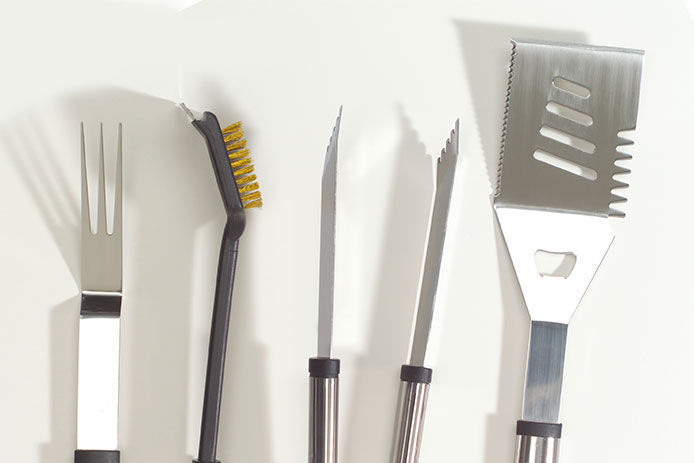 A basic set of grilling tools. One fork, brush, tongs, and spatula