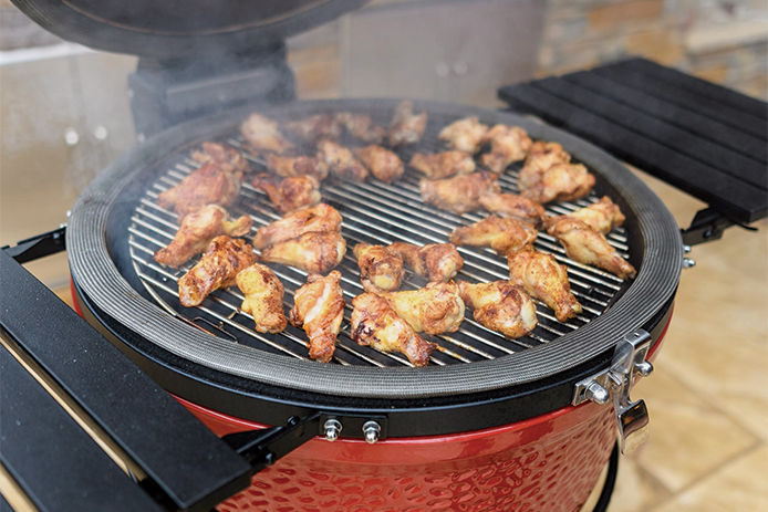 Red Kamado Grill cooking chicken wings