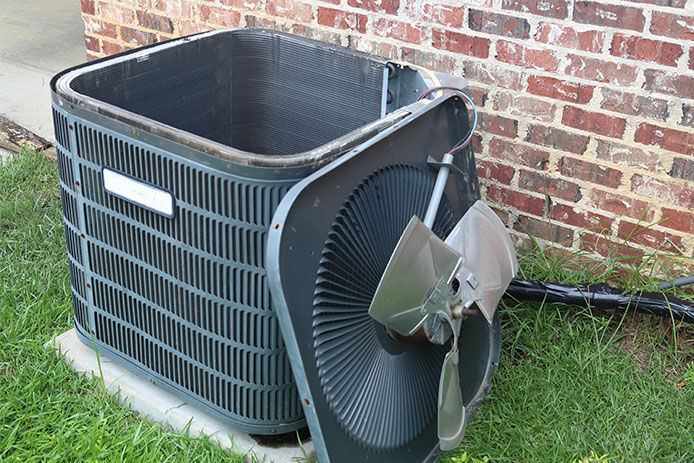 Fan of the HVAC leaning up against the main unit