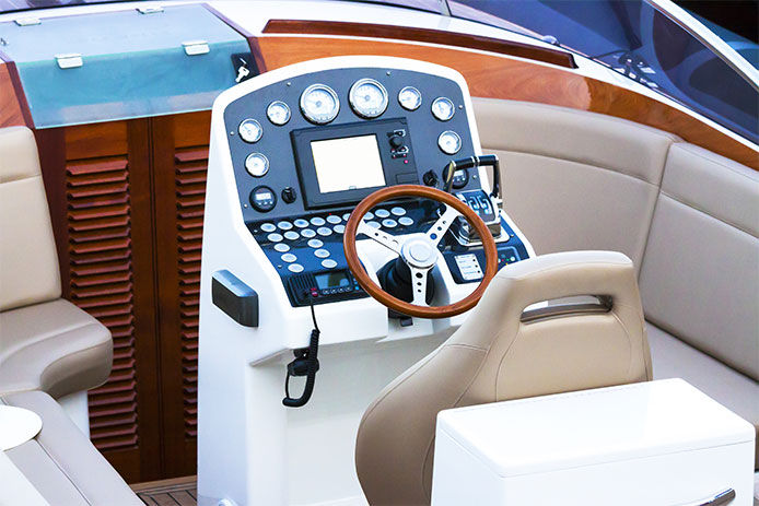 Elevated view of white modern luxury speedboat rudder control panel and leather seats, full frame horizontal composition