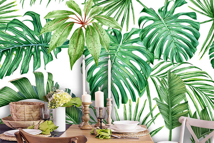 Green botanical wallpaper behind a dining table