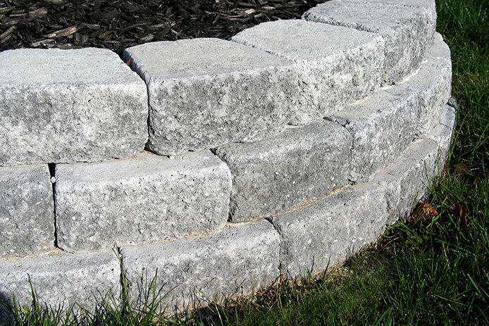 A stock photo of a retaining wall using gray paver stones
