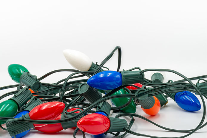 Vintage tangled Christmas light bulbs. White background