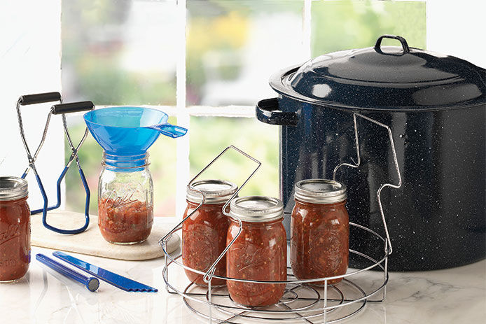 All the materials you would need to start canning on a kitchen countertop