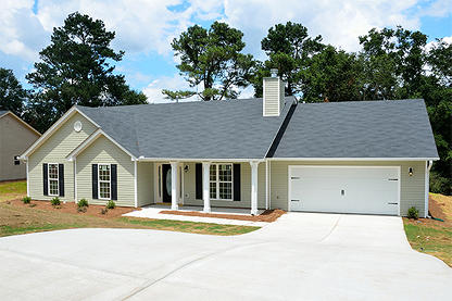 A family style home with a new concrete driveway and a two garage door home