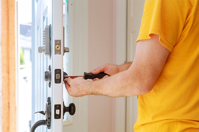 Man changing the locks on a front door
