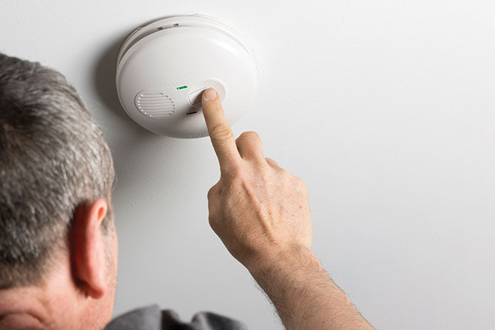 Man testing a smoke detector