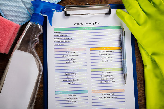 High Angle View Of Weekly Cleaning Plan Form With Pen On Clipboard