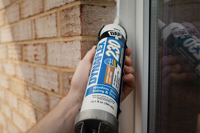 A close up image of Dyna Flex Caulk in a caulking gun by DAP