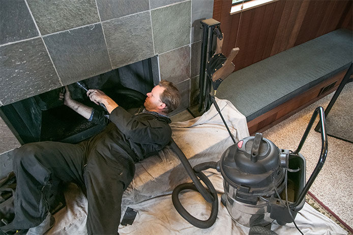 Man cleaning out chimney