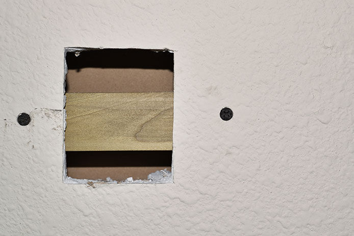 Adding a support behind the hole in teh drywall