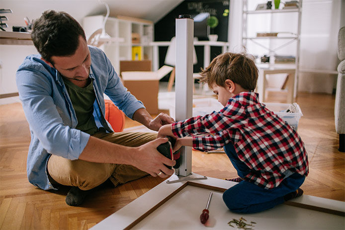 Father and son putting togther a table