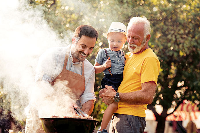 Two men and a boy grilling