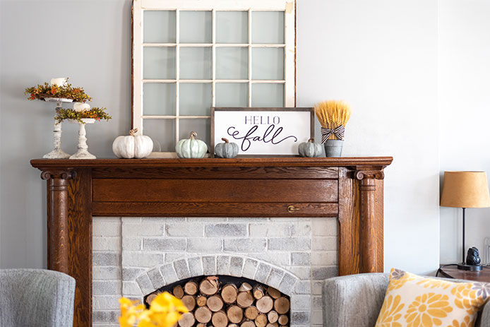 Home decor on the top of the fireplace mantle in a living room
