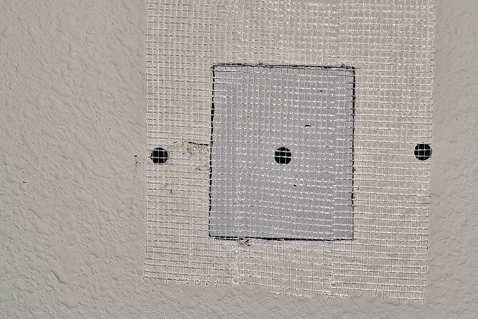 Added a small piece of drywall to fit in the hole and mesh overtop of it