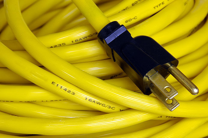 Close-up of a yellow extension cord wrapped