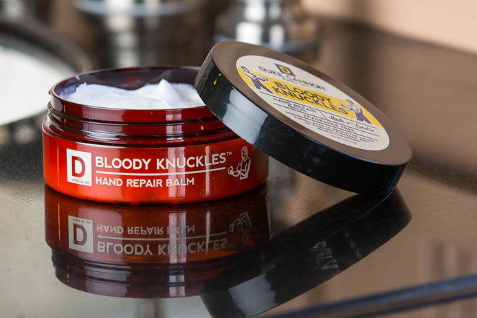 A product lifestyle image of Duke Cannon Bloody Knuckles Hand Repair Balm 
