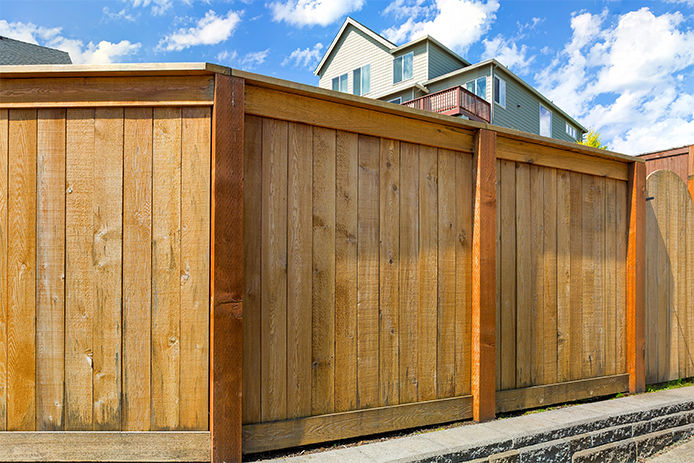 A wooden fence outside a residential home 