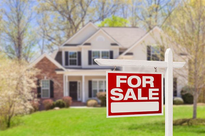 For sale sign in front of a house