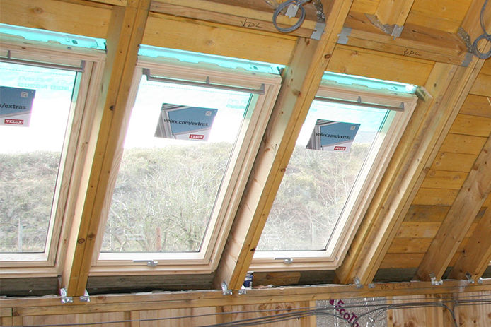 Wood framing of three skylights from the inside of the attic