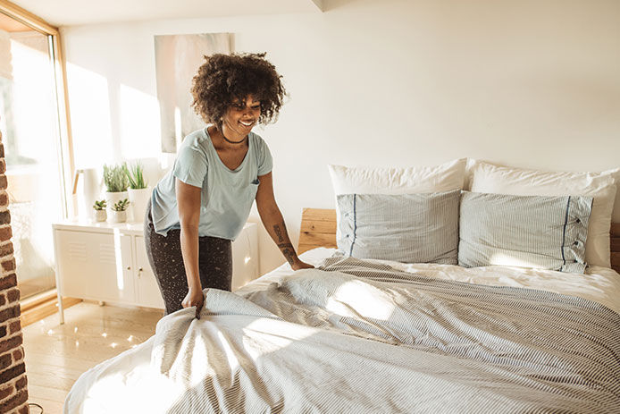 A woman making a bed