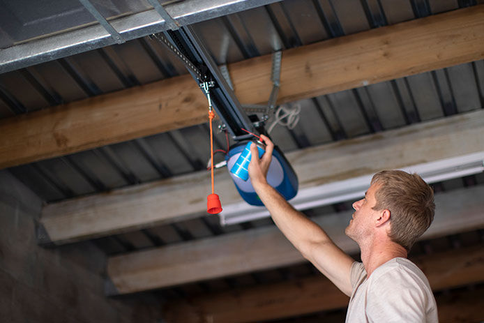 Man greasing a garage door