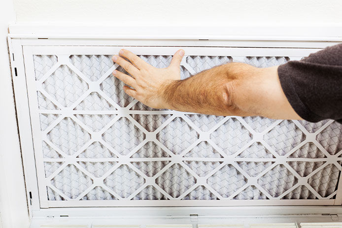 Person placing a new air filter