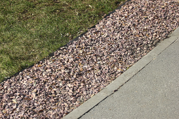 A stone hardscape lining a driveway