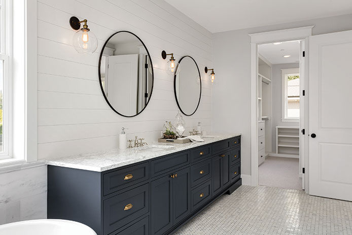 White bathroom with navy cabinetry